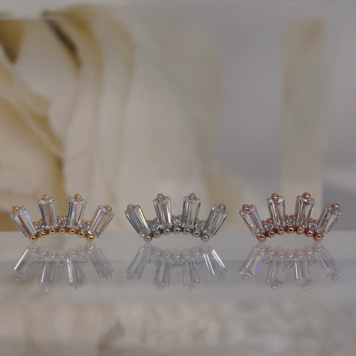 Front view of Buddha Jewelry’s “Crown Jewels” in 14k yellow, white, and rose gold, featuring an ornate crystal arrangement in a crown-like silhouette.