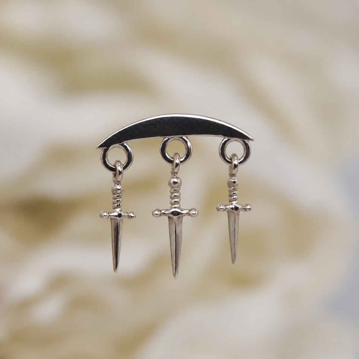 Norvoch 14k gold “Hidden Helix with Daggers” threaded end in yellow, white, and rose gold, featuring a sculptural curved design accented with three delicate dangling dagger charms