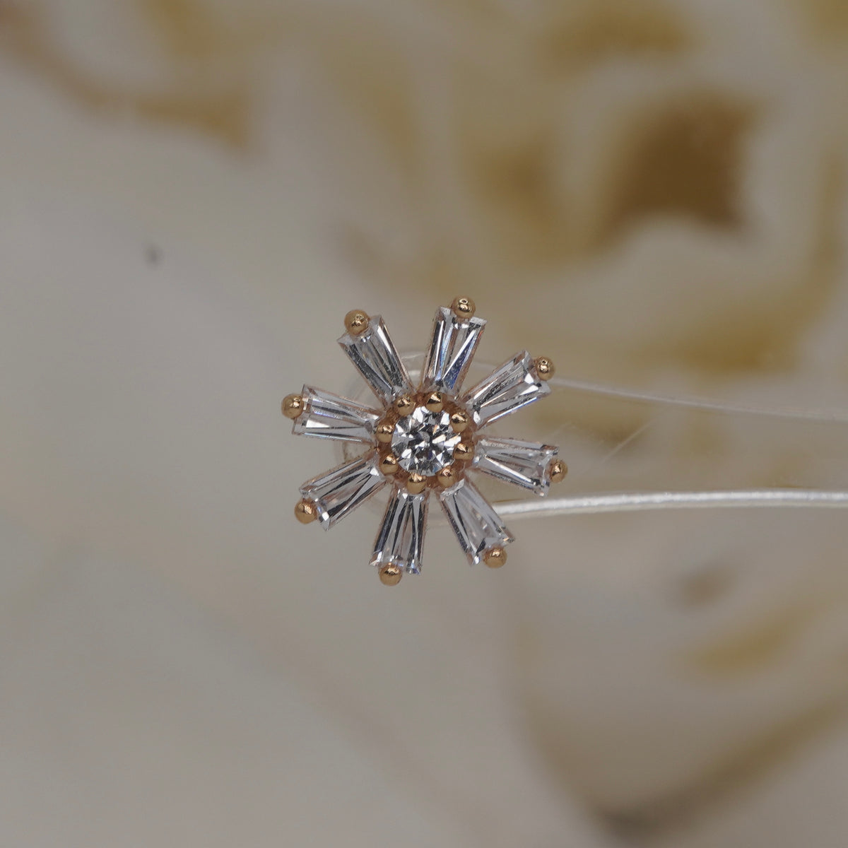 Front view of Buddha Jewelry’s “Deliah” in 14k yellow gold, featuring a central crystal framed by tapered baguette crystal petals.