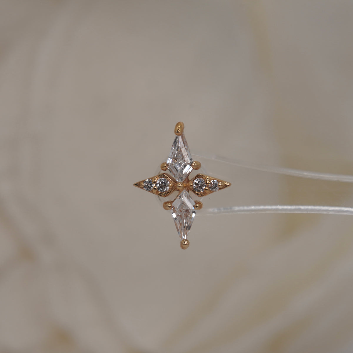Front view of Buddha Jewelry’s “Feeling Myself” in 14k yellow gold, featuring a sleek, cross-like design accented with crystals.