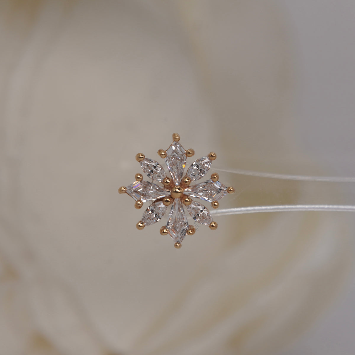 Front view of Buddha Jewelry’s “Hauteness” in 14k yellow gold, featuring marquise crystals arranged in a layered starburst.