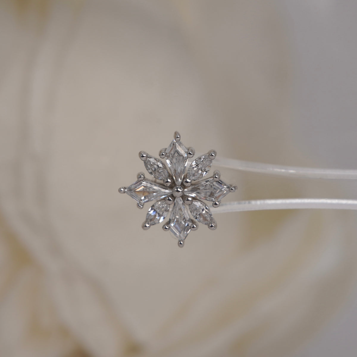 Front view of Buddha Jewelry’s “Hauteness” in 14k white gold, featuring marquise crystals arranged in a layered starburst.
