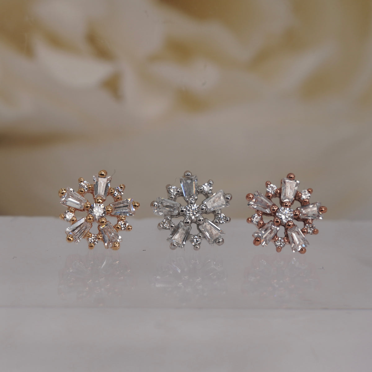 Front view of Buddha Jewelry’s “Audacious” in 14k yellow, white, and rose gold, featuring marquise and round crystals in a flower-like cluster.