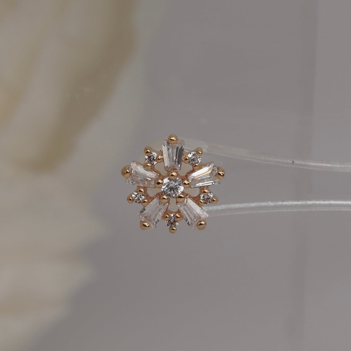 Front view of Buddha Jewelry’s “Audacious” in 14k yellow gold, featuring a floral cluster of marquise and round crystals.