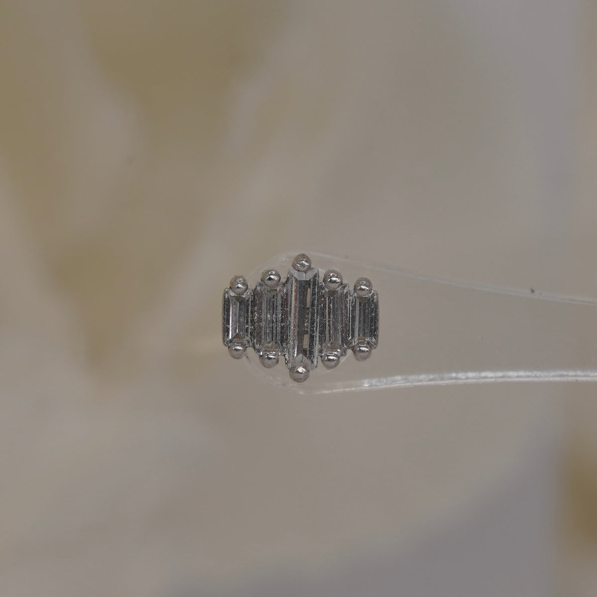 Front view of Buddha Jewelry’s “Evolution” in 14k white gold, featuring elongated crystals arranged in a clean, graduated row.