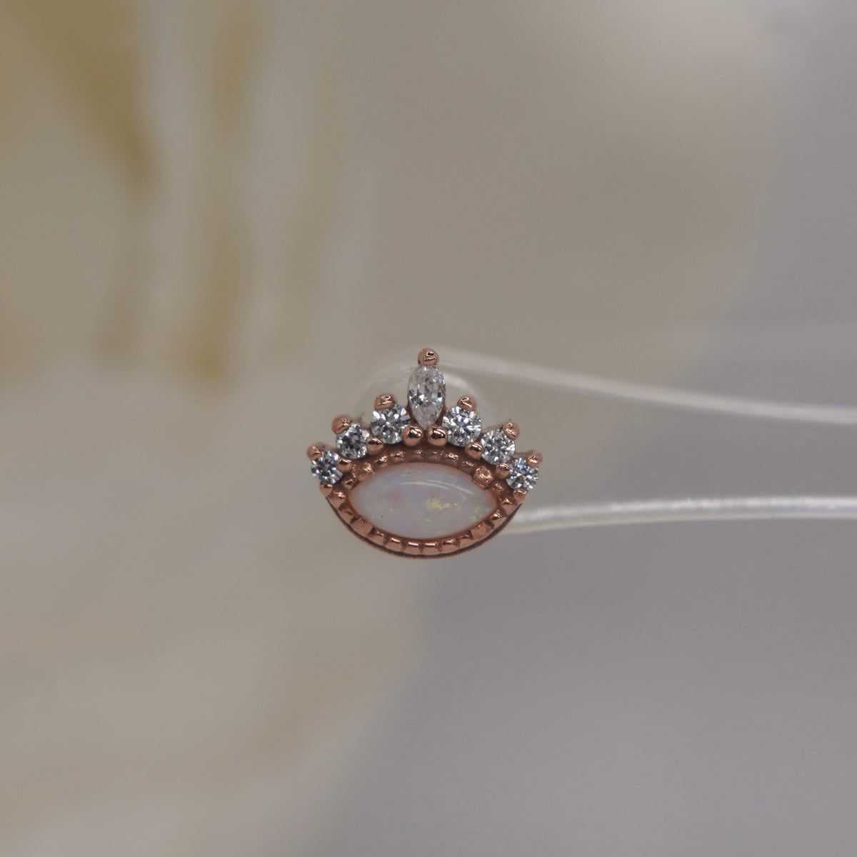 Front view of Buddha Jewelry’s “Enchant” in 14k rose gold, featuring a glowing opal accented by a crown of crystals.
