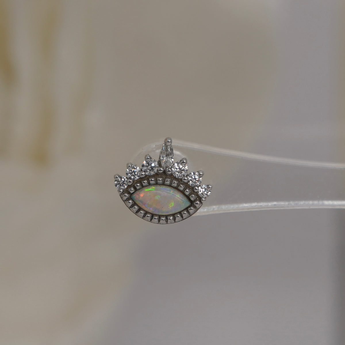 Front view of Buddha Jewelry’s “Enchant” in 14k white gold, featuring a glowing opal accented by a crown of crystals.