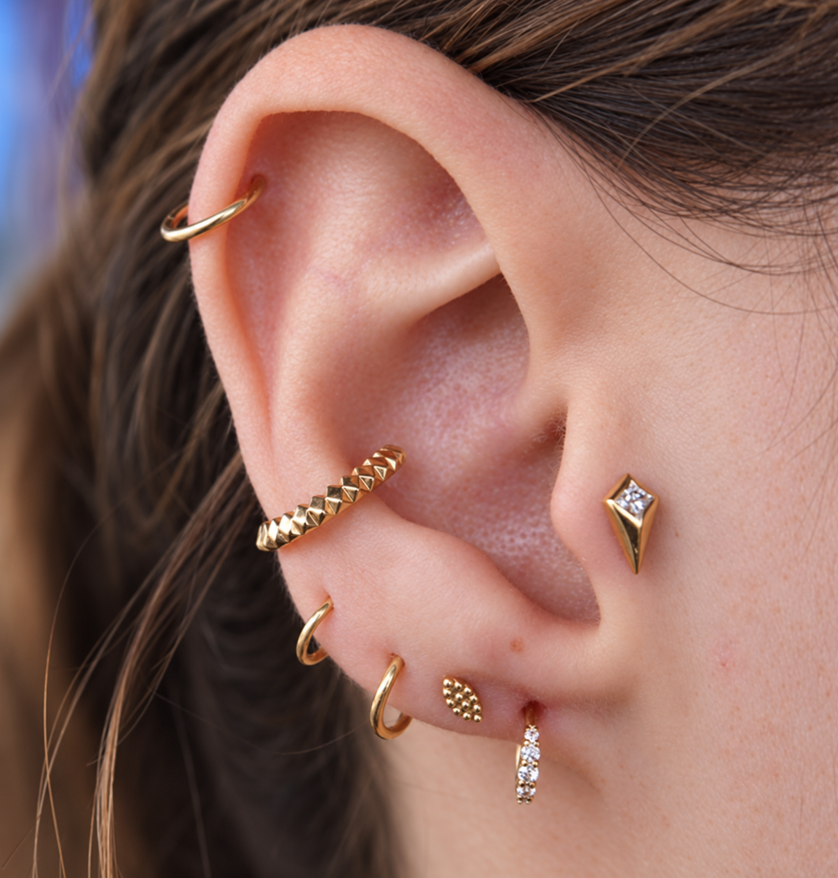 Petite Carbonaro seam ring worn in a conch piercing