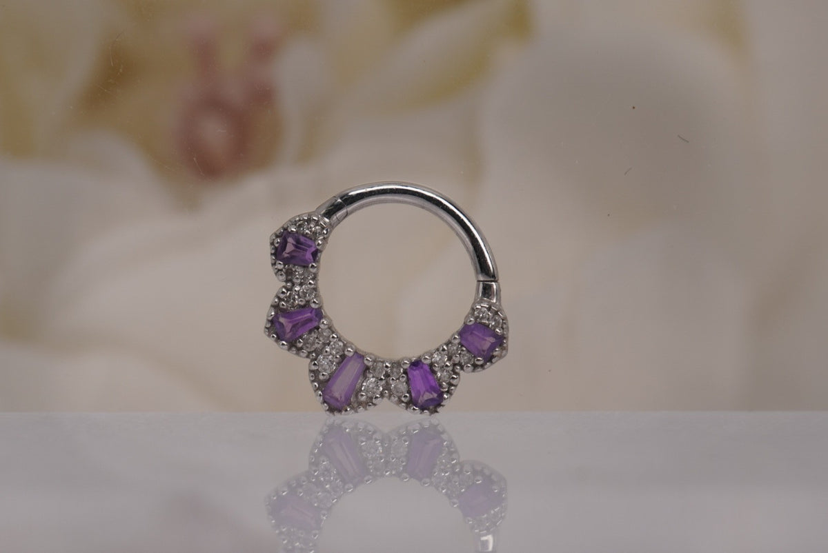 Front view of Buddha Jewelry’s “Gilty Pleasure” clicker in 14k white gold, featuring a curved fan of amethyst baguettes accented with genuine white diamonds.