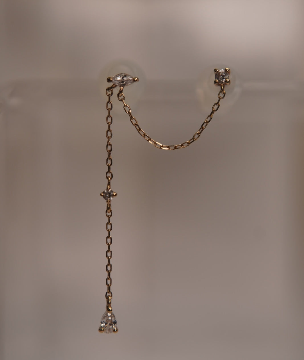 Angled view of the two threadless ends and crystal-accented gold chain.