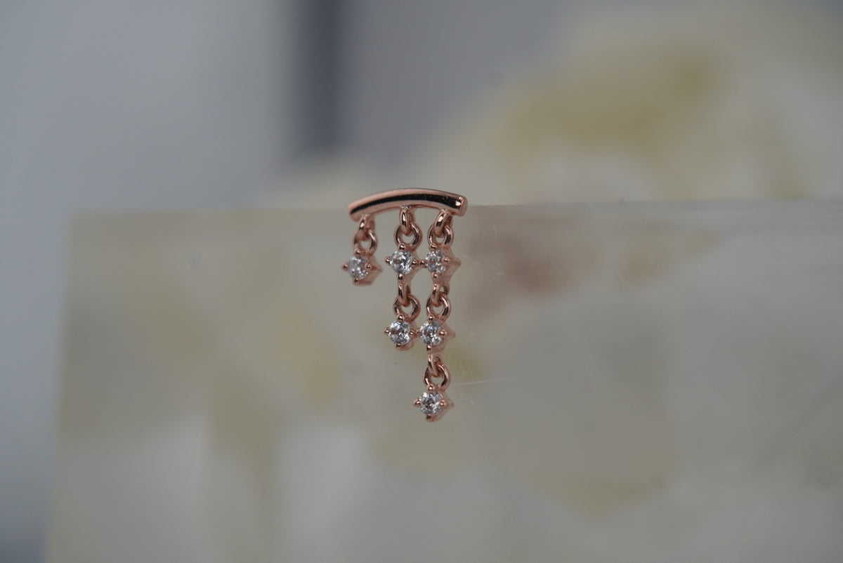 Side view of And Beyond in rose gold with three crystal-accented chains.