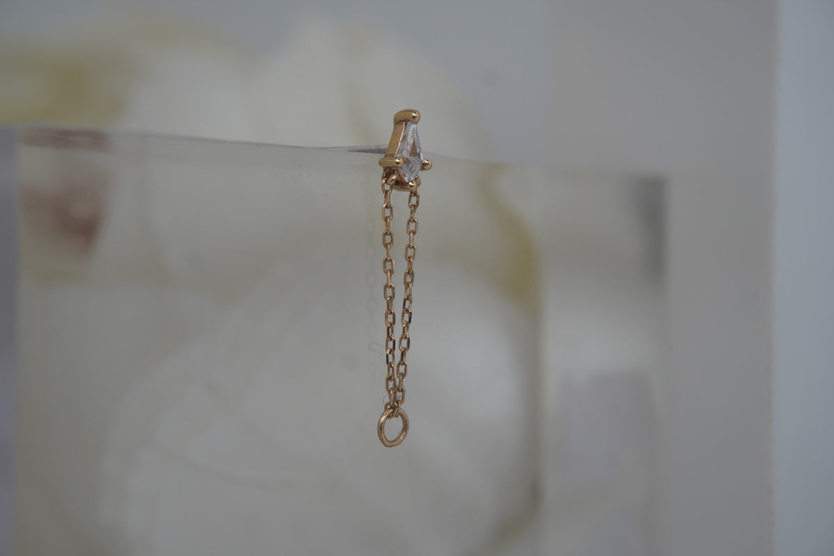 Angled view showing the kite-cut crystal and delicate connecting chain.