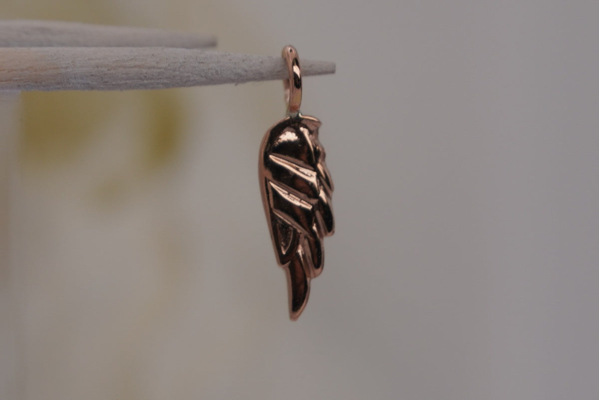 Side Facing Norvoch 14k Angel Wing Charm pendant in rose gold piercing charm, side view
