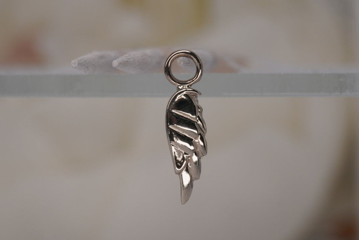 Forward Facing Norvoch 14k Angel Wing Charm in Yellow gold piercing chain, side view view