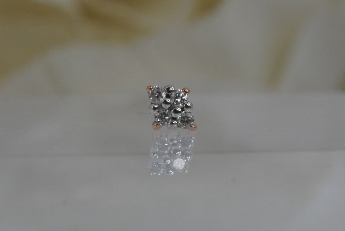 Front view of Buddha Jewelry’s “Belle” in 14k rose gold, featuring four round-cut crystals in a diamond-shaped arrangement with white center prongs.
