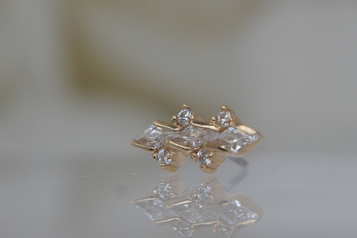 Angled view showing the prong-set crystals and yellow gold setting of Limited Edition #138