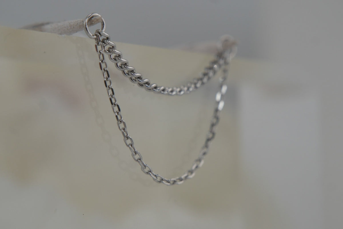Angled view of Buddha Jewelry’s “Diamond Cut + Side Chain” in 14k white gold, featuring two delicate chains with subtle texture and a layered drape.