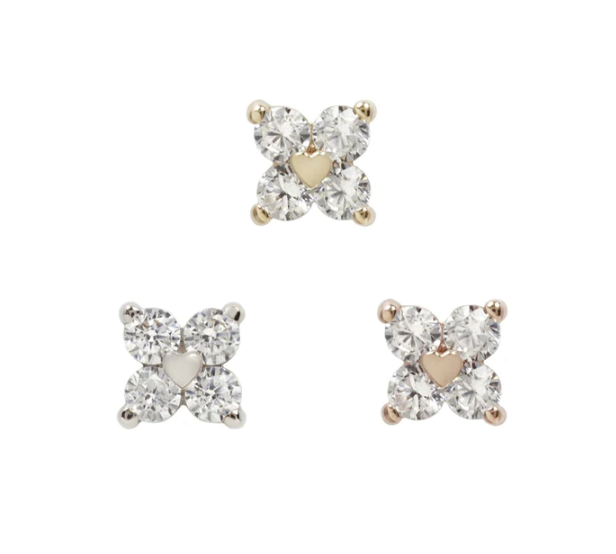 Stock image of Buddha Jewelry’s “Corazon” in 14k yellow, white, and rose gold, featuring crystal flowers with polished gold heart centers.