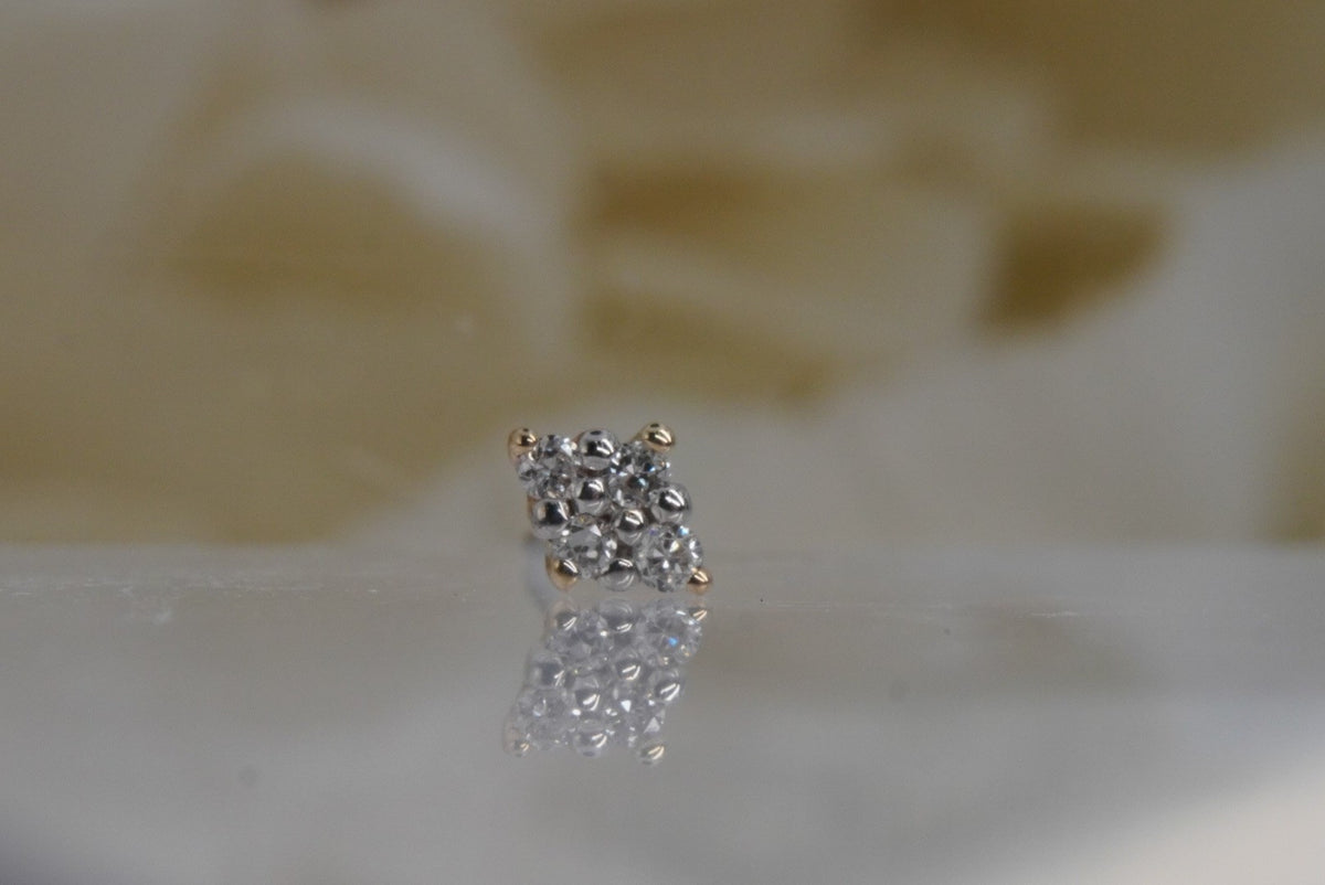 Front view of Buddha Jewelry’s “Belle” in 14k yellow gold, featuring four round-cut crystals in a diamond-shaped arrangement with white center prongs.