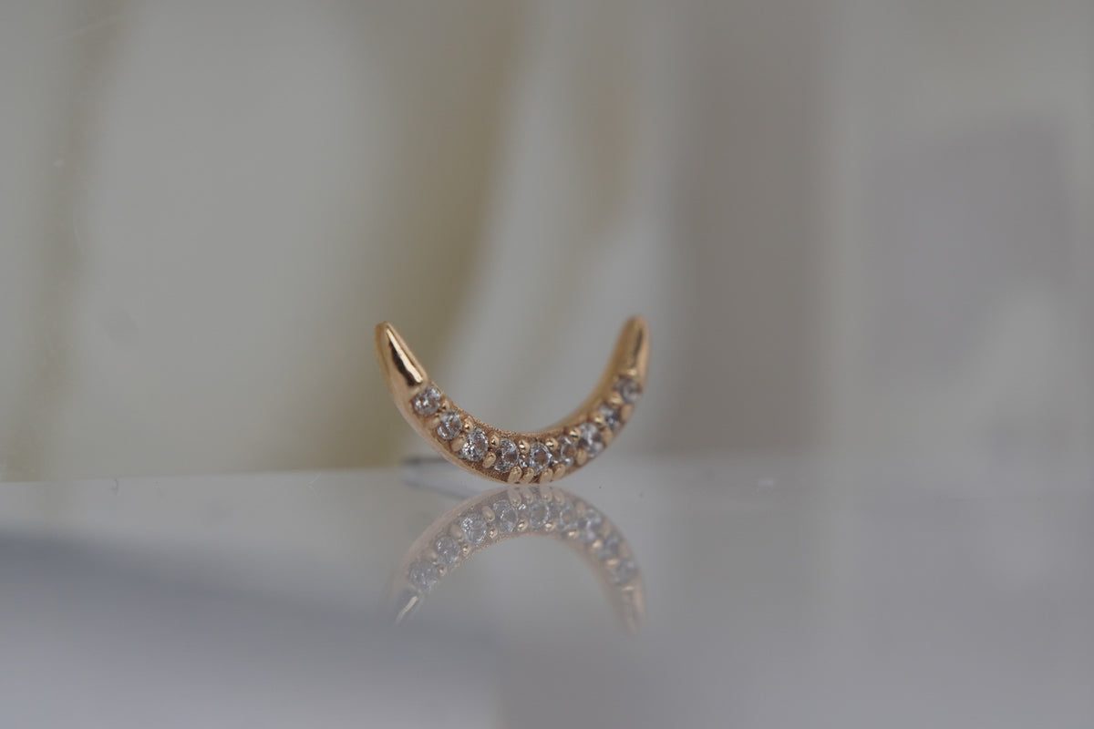 Angled view showing the curved moon shape and crystal settings.