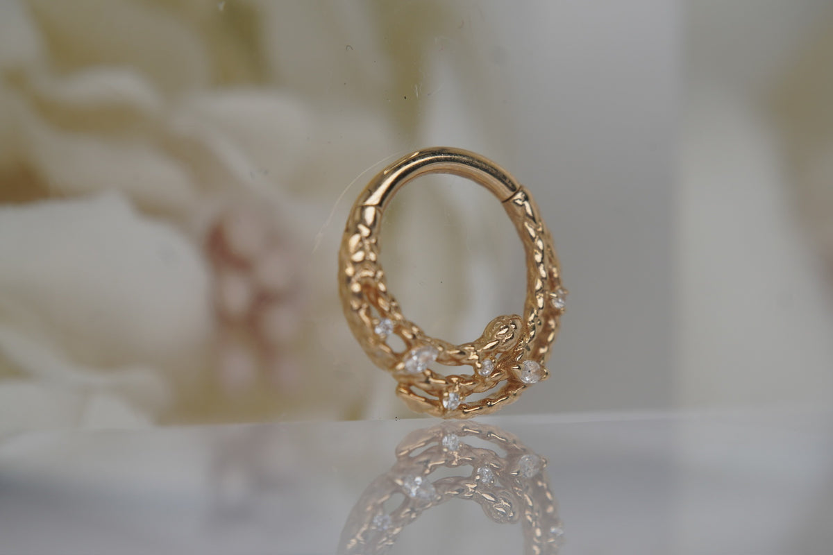 Angled view showing the serpent’s raised 3D shape and gold detailing.