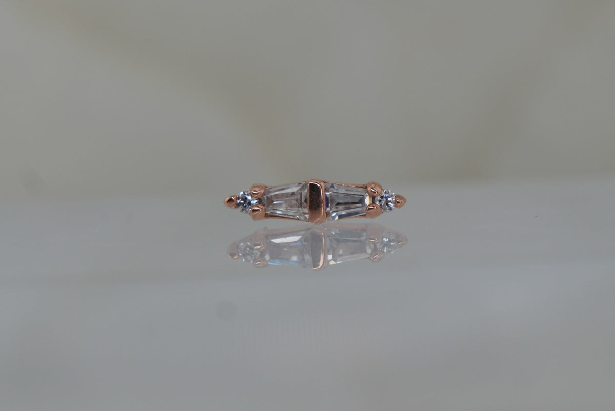 Front view of Buddha Jewelry’s “Essential” in 14k rose gold, featuring alternating crystals in a clean, elongated linear design.