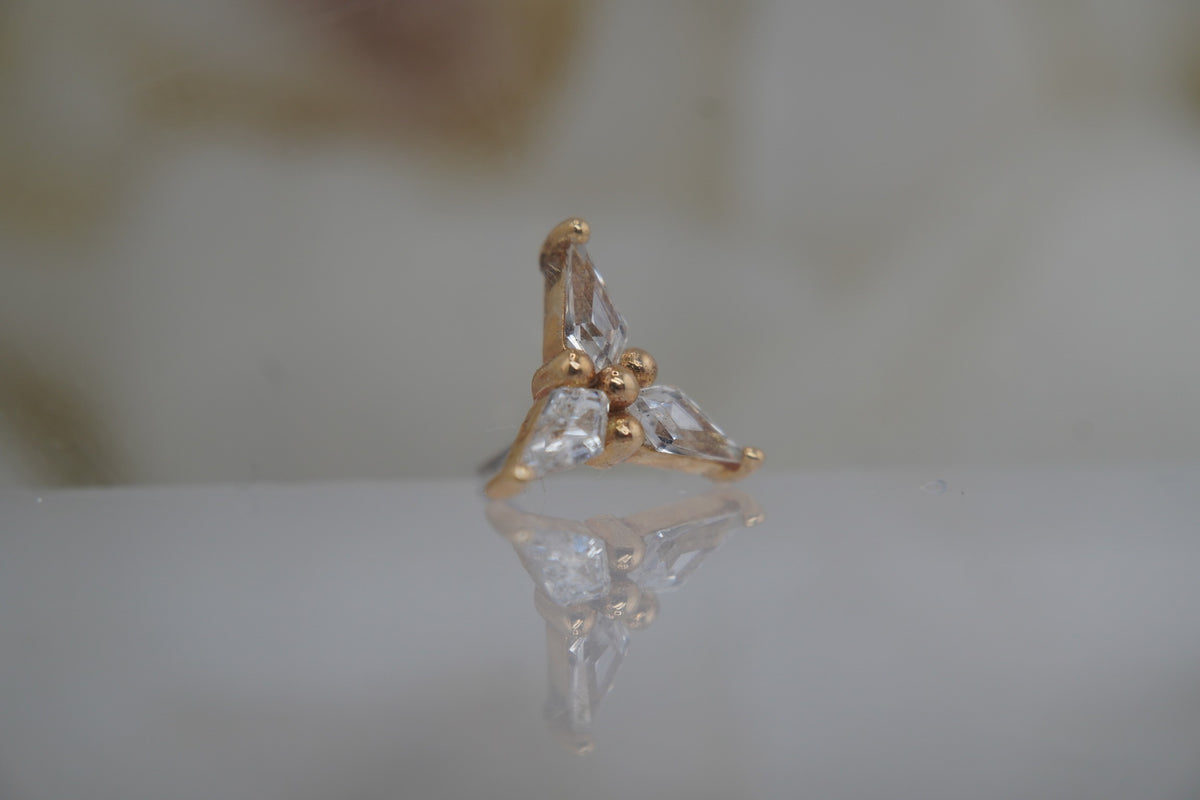 Angled view showing the clustered pear-cut crystals and gold settings.