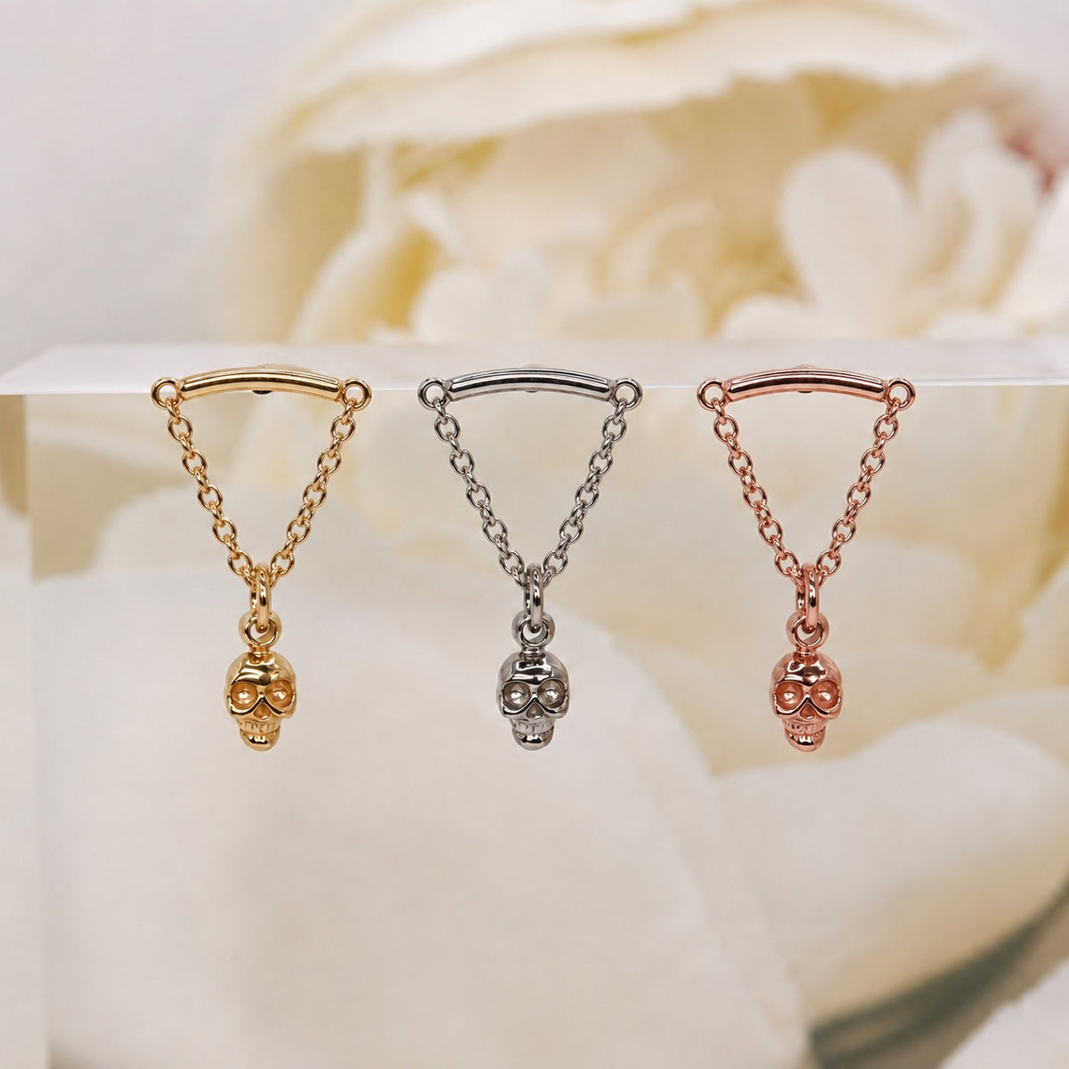 Glide Spooky Hidden Helix 16g yellow gold white gold rose gold against a soft white rose background.