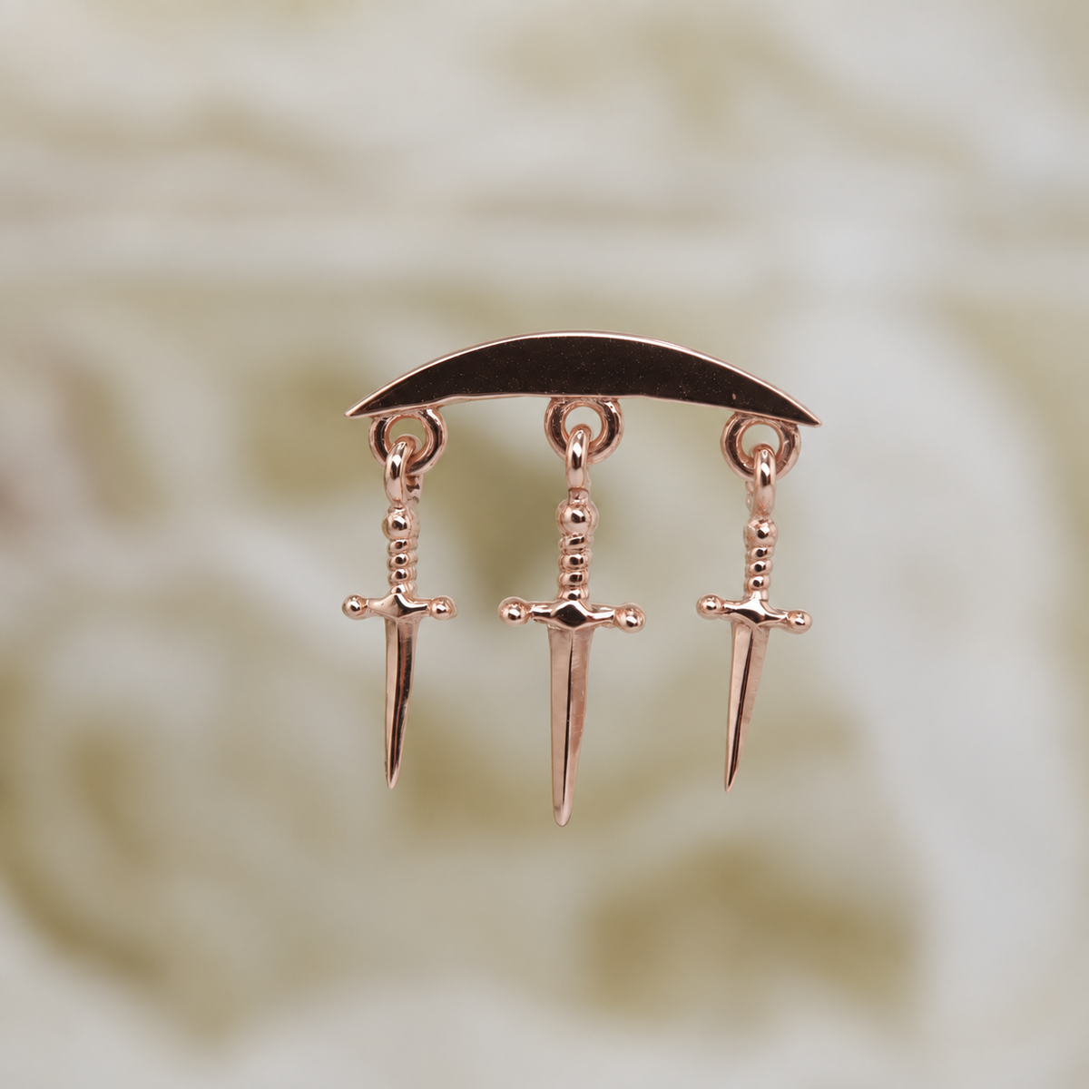 Norvoch 14k gold “Hidden Helix with Daggers” threaded end in yellow, white, and rose gold, featuring a sculptural curved design accented with three delicate dangling dagger charms