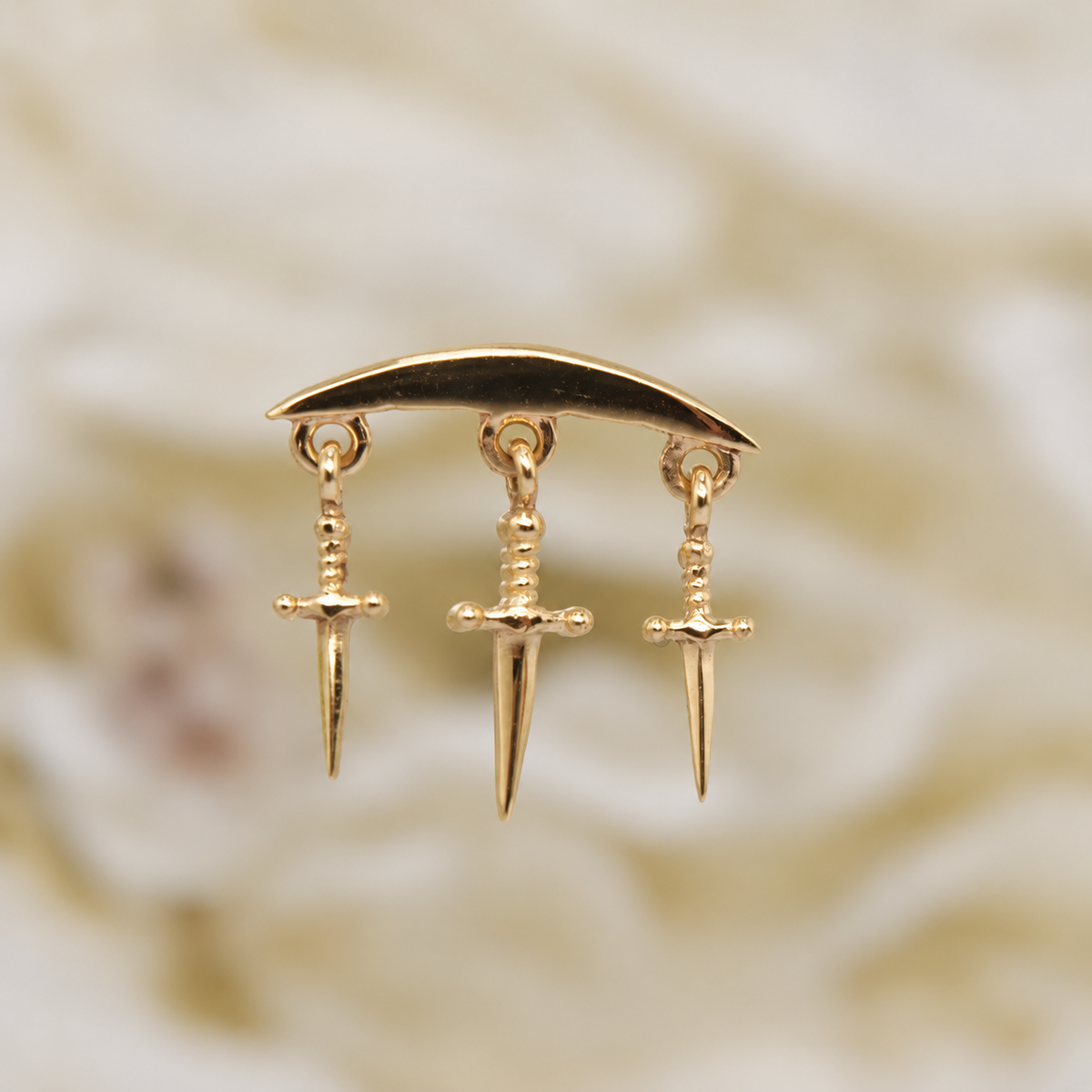 Norvoch 14k gold “Hidden Helix with Daggers” threaded end in yellow, white, and rose gold, featuring a sculptural curved design accented with three delicate dangling dagger charms