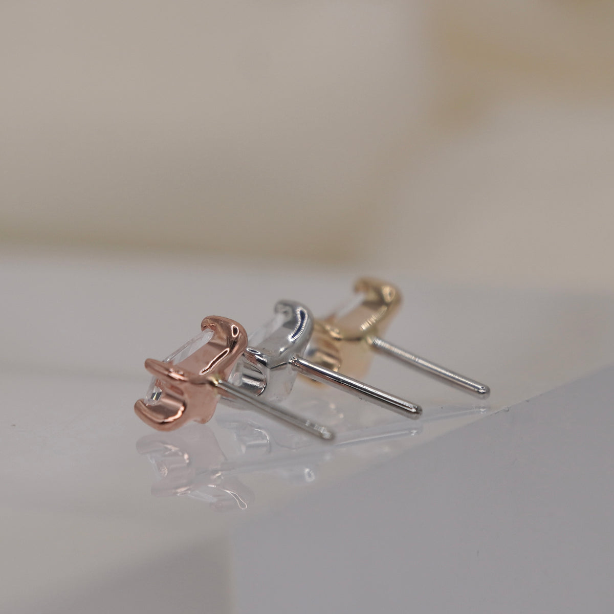 Buddha Jewelry 14k Gold Nolita kite cut white crystal in a prong setting Yellow Gold White Gold Rose Gold threadless group angled back view showing threadless pin