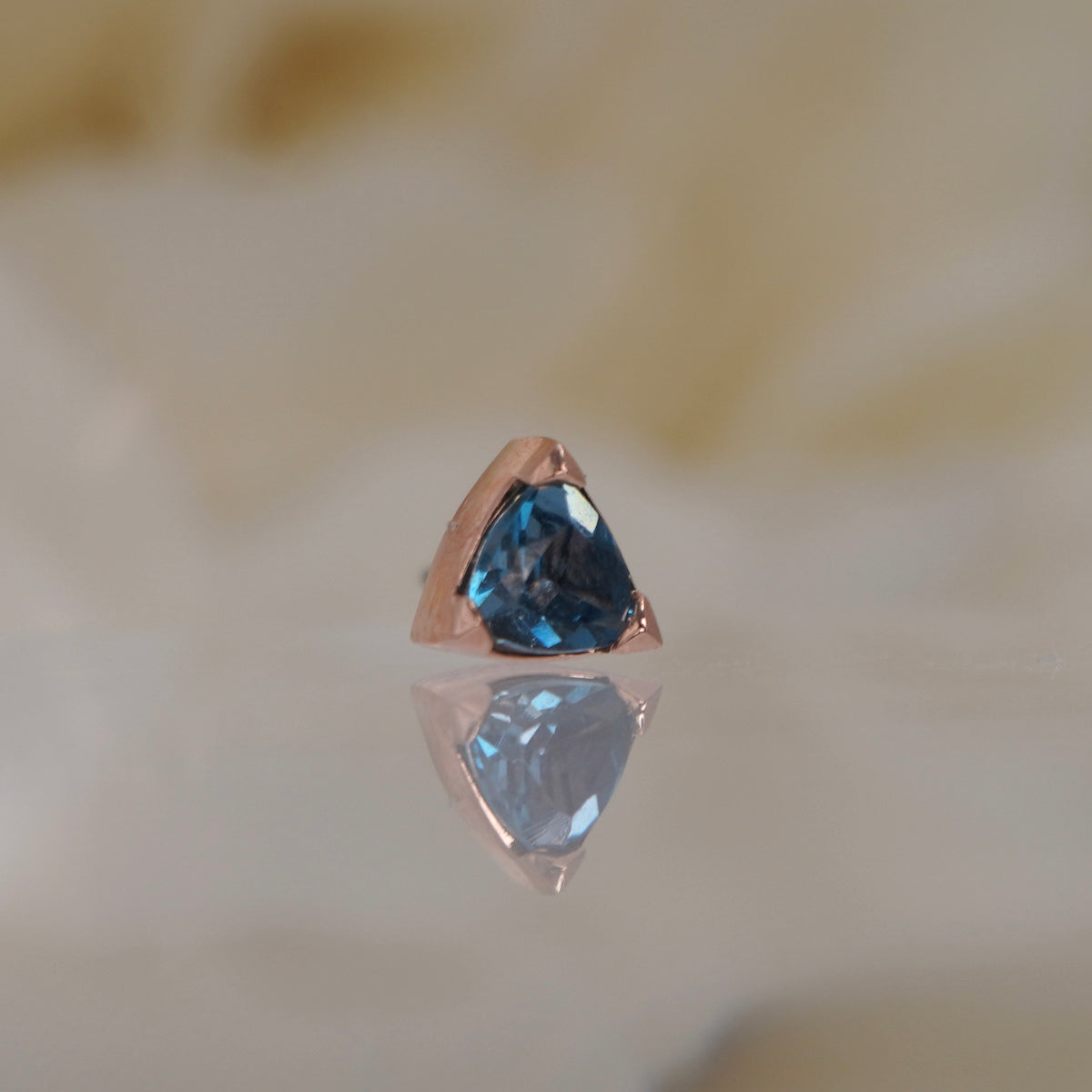 Tether 14k Gold Lennox with London blue topaz trillion threadless rose gold side view showing half prong half bezel setting 
