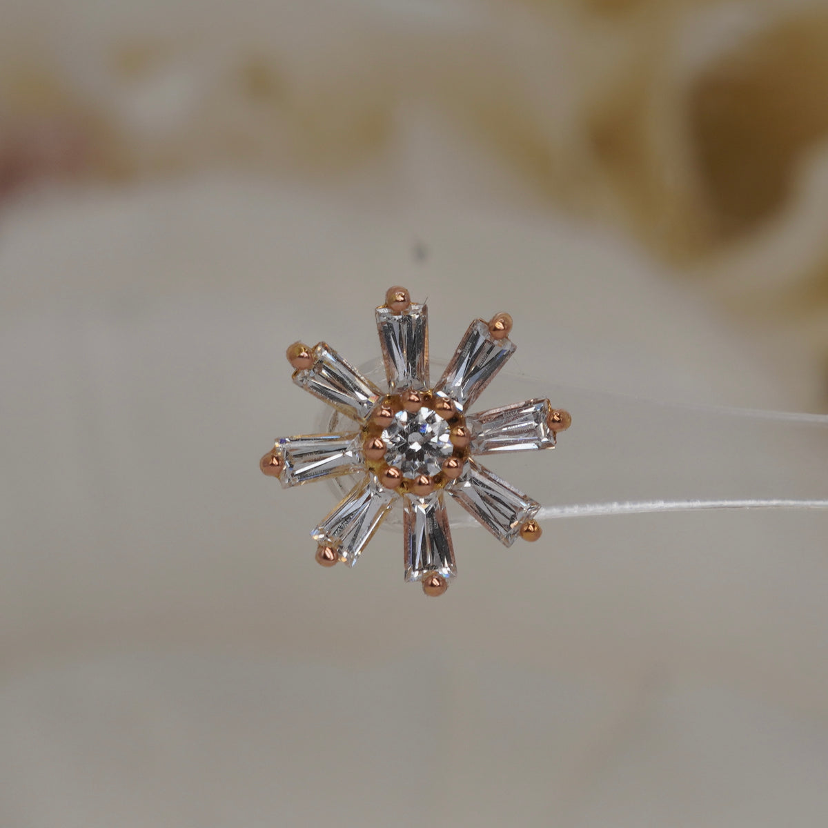 Front view of Buddha Jewelry’s “Deliah” in 14k rose gold, featuring a central crystal framed by tapered baguette crystal petals.
