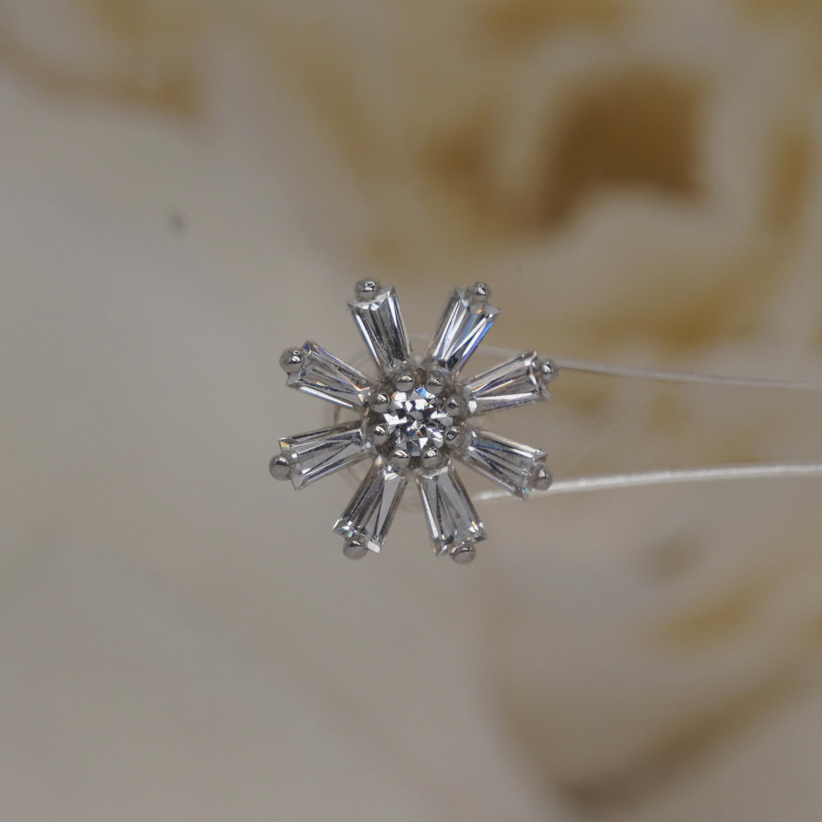 Front view of Buddha Jewelry’s “Deliah” in 14k white gold, featuring a central crystal framed by tapered baguette crystal petals.