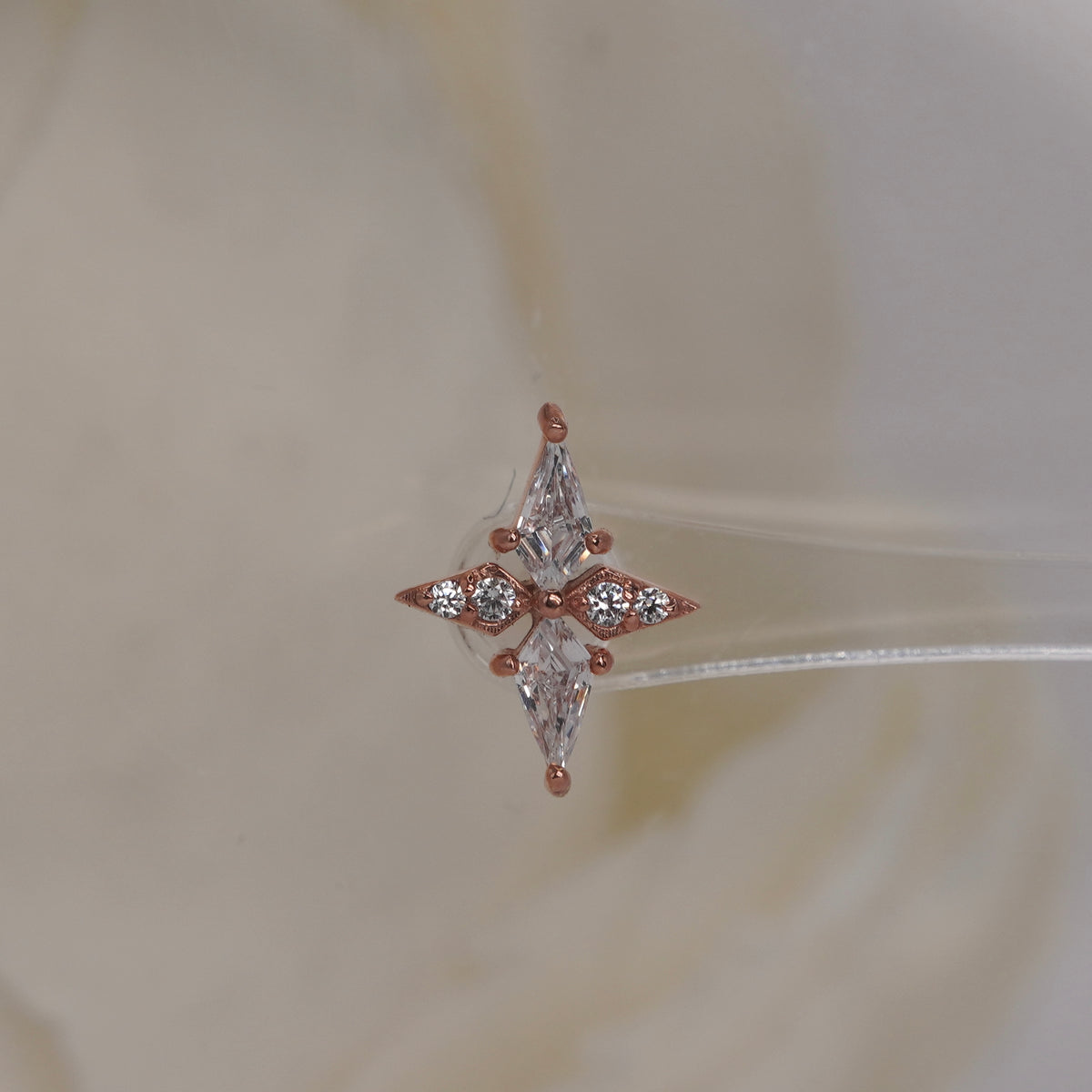 Front view of Buddha Jewelry’s “Feeling Myself” in 14k rose gold, featuring a sleek, cross-like design accented with crystals.