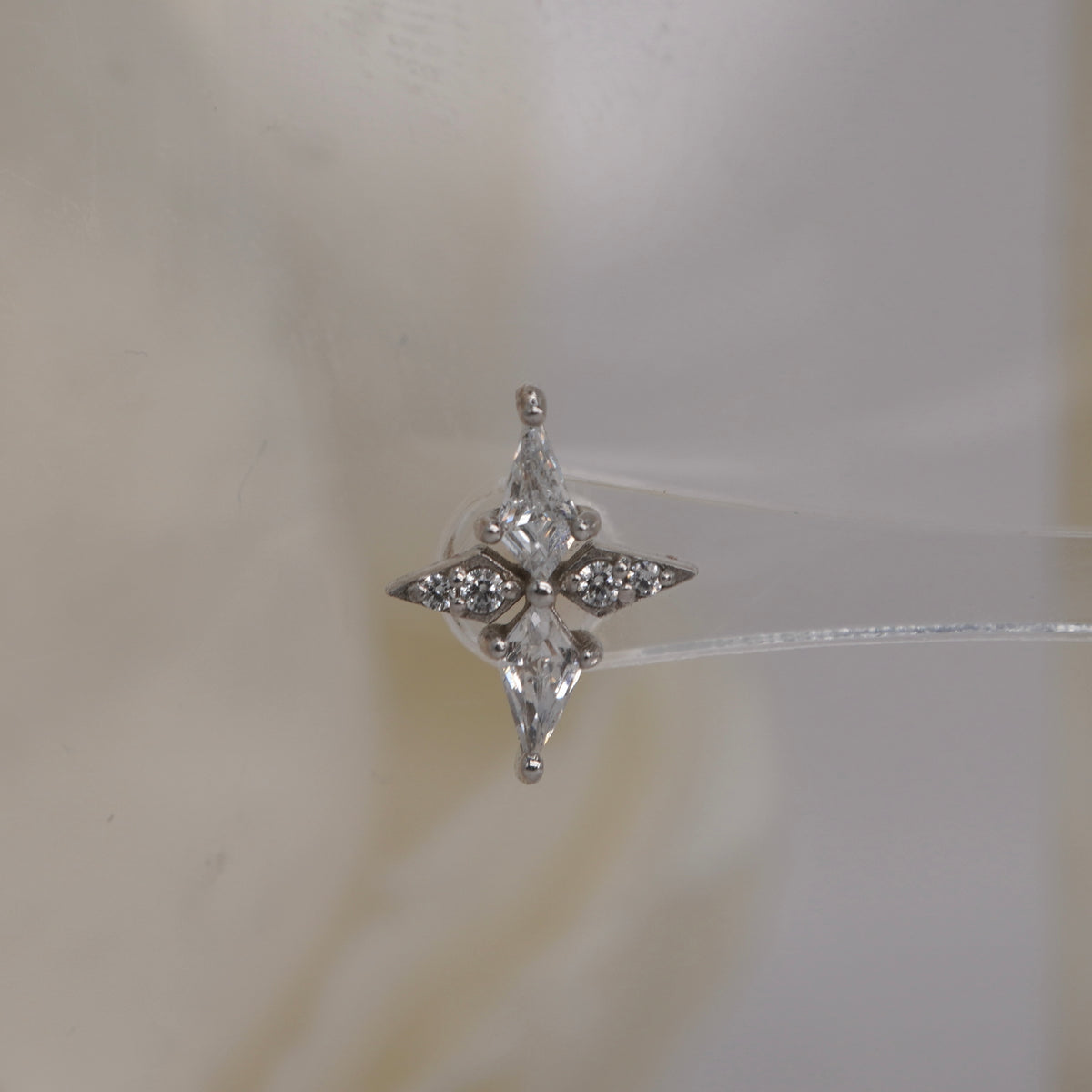 Front view of Buddha Jewelry’s “Feeling Myself” in 14k white gold, featuring a sleek, cross-like design accented with crystals.