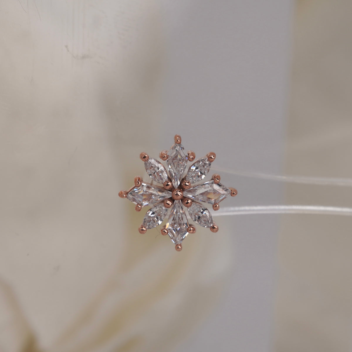 Front view of Buddha Jewelry’s “Hauteness” in 14k rose gold, featuring marquise crystals arranged in a layered starburst.