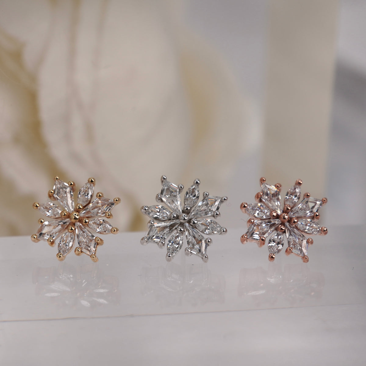 Front view of Buddha Jewelry’s “Hauteness” in 14k yellow, white, and rose gold, featuring a starburst cluster of marquise crystals.