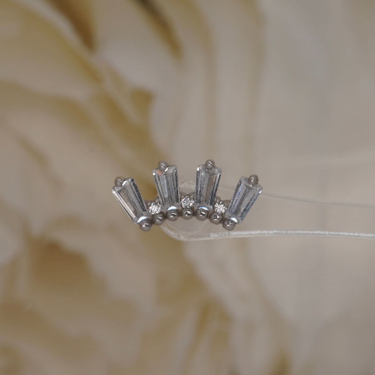 Front view of Buddha Jewelry’s “Crown Jewels” in 14k white gold, featuring shimmering crystals arranged in an ornate crown-like shape.
