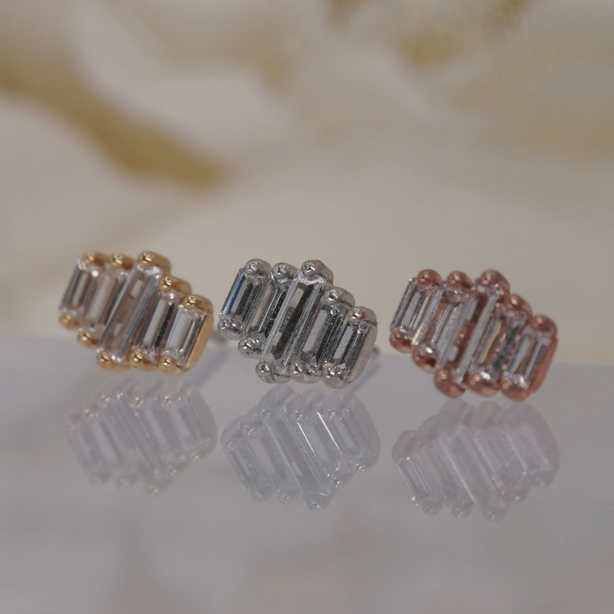 Angled view of Buddha Jewelry’s “Evolution” in 14k yellow, white, and rose gold, showing the varying crystal sizes and dimensional, structured silhouette.