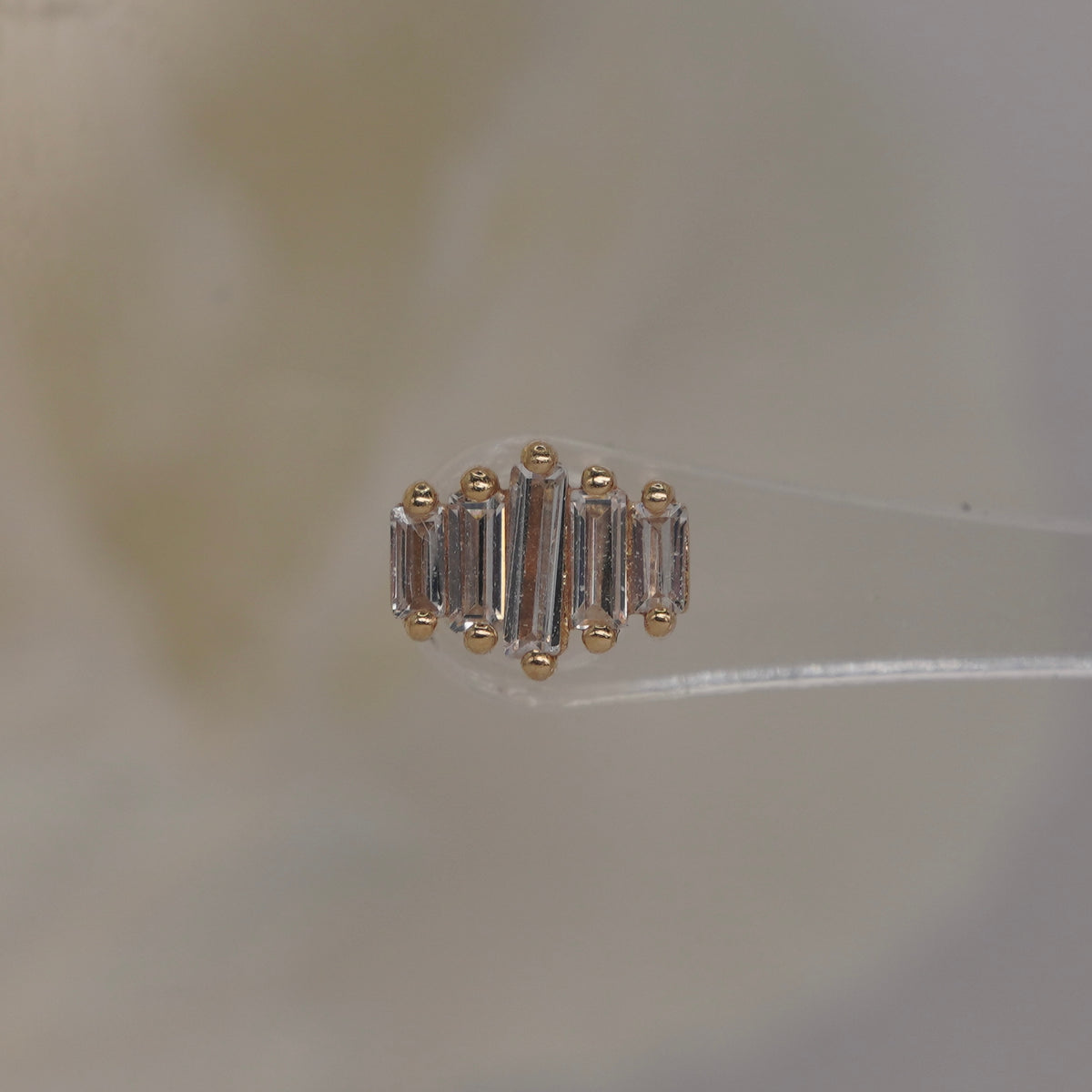 Front view of Buddha Jewelry’s “Evolution” in 14k yellow gold, featuring elongated crystals arranged in a clean, graduated row.