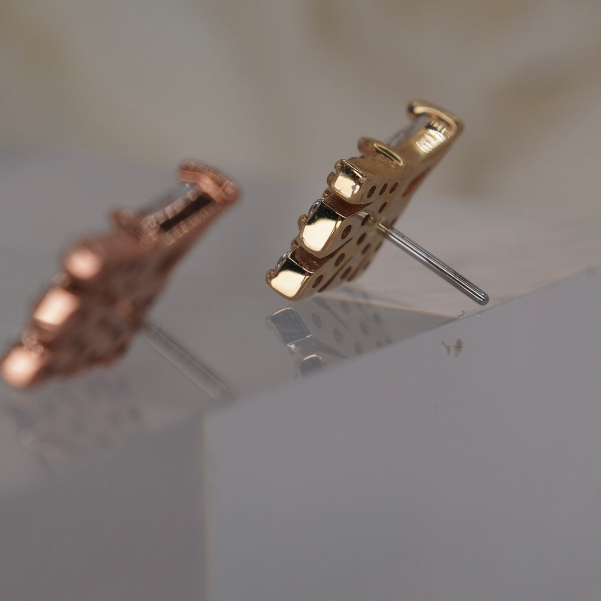Back view of Buddha Jewelry’s “Savor,” showing the rear of the kite-shaped crystal setting, stone fan, and attachment detail.