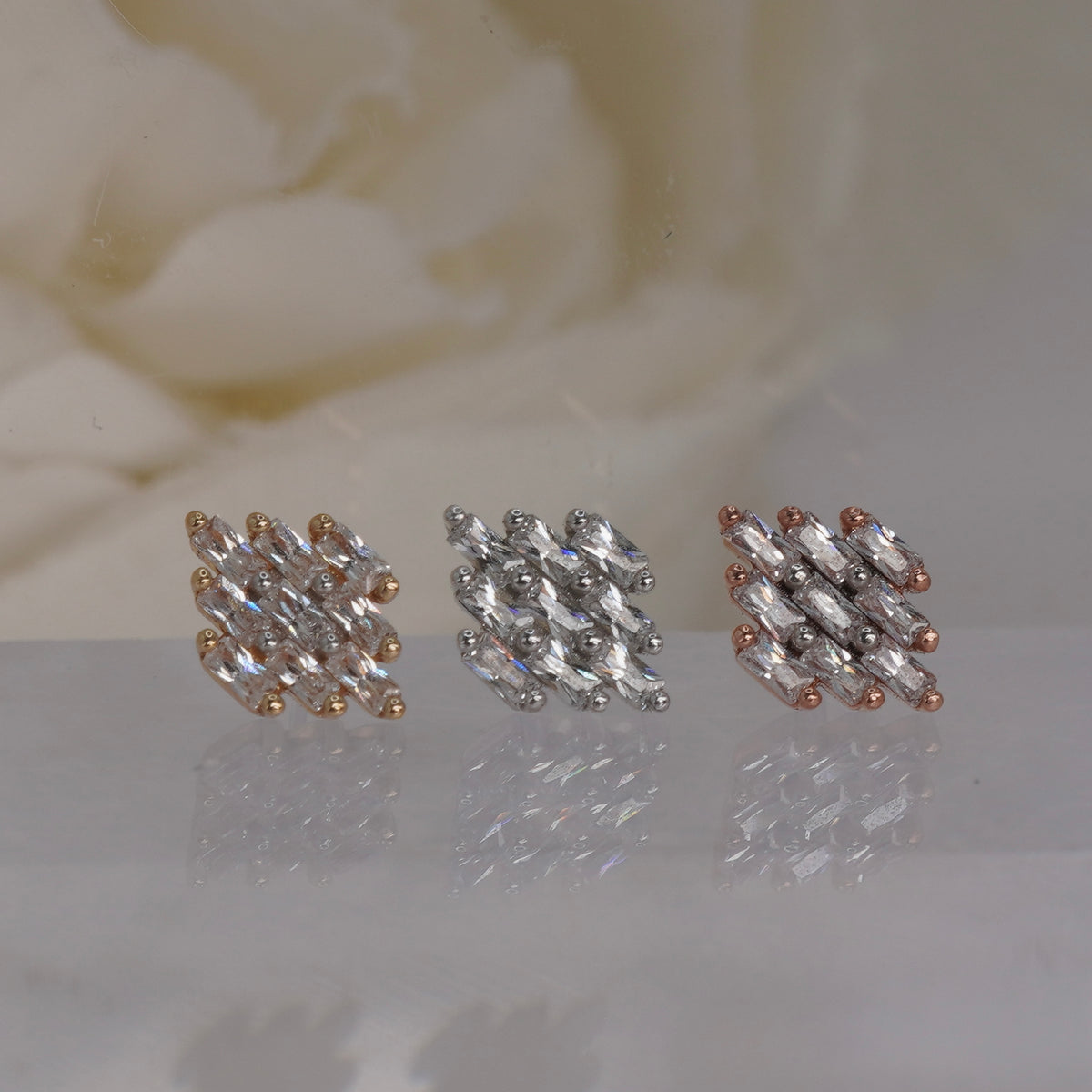 Front view of Buddha Jewelry’s “Wonder” in 14k yellow, white, and rose gold, featuring a fan-shaped cluster of elongated crystals.