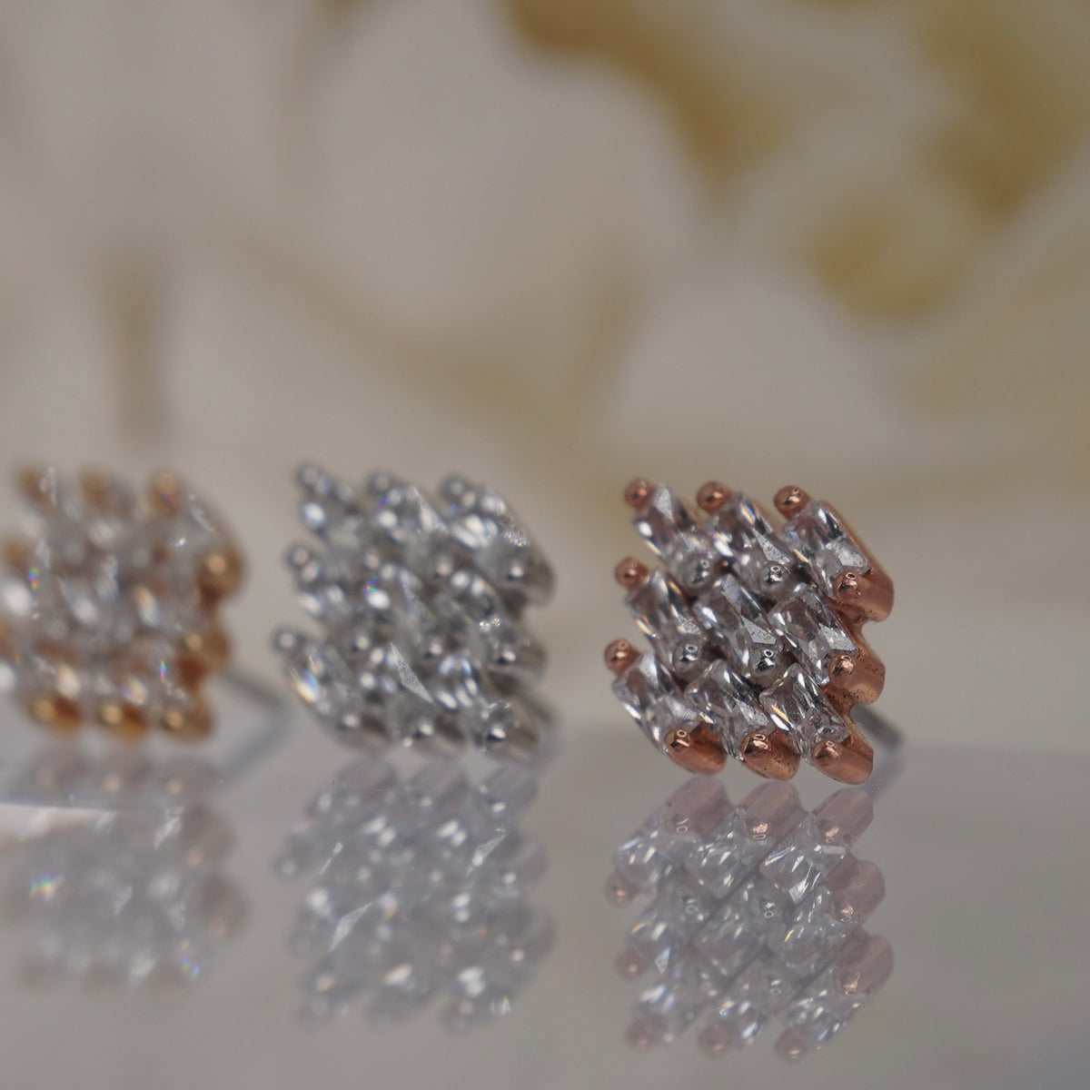 Angled view of Buddha Jewelry’s “Wonder” in 14k yellow, white, and rose gold, showing the dimensional arrangement of outward-fanning crystals.