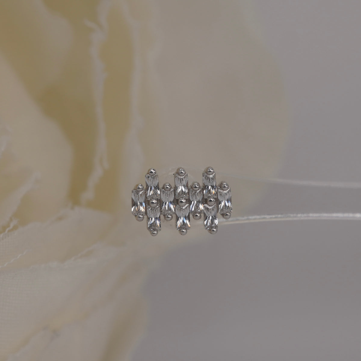 Front view of Buddha Jewelry’s “Imagine” in 14k white gold, featuring elongated crystals in a compact, structured arrangement.