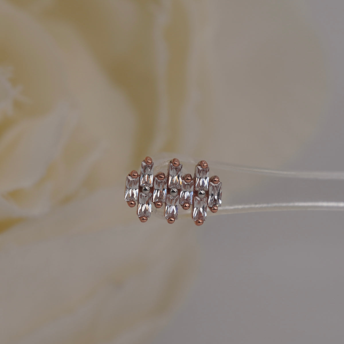 Front view of Buddha Jewelry’s “Imagine” in 14k rose gold, featuring elongated crystals in a compact, structured arrangement.