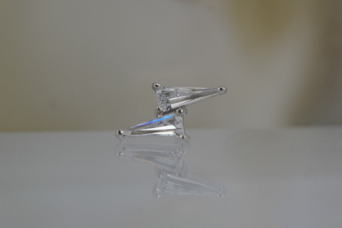 Front view of Buddha Jewelry’s “Electrify” in 14k white gold, featuring elongated crystals arranged in a mirrored double-spike design.
