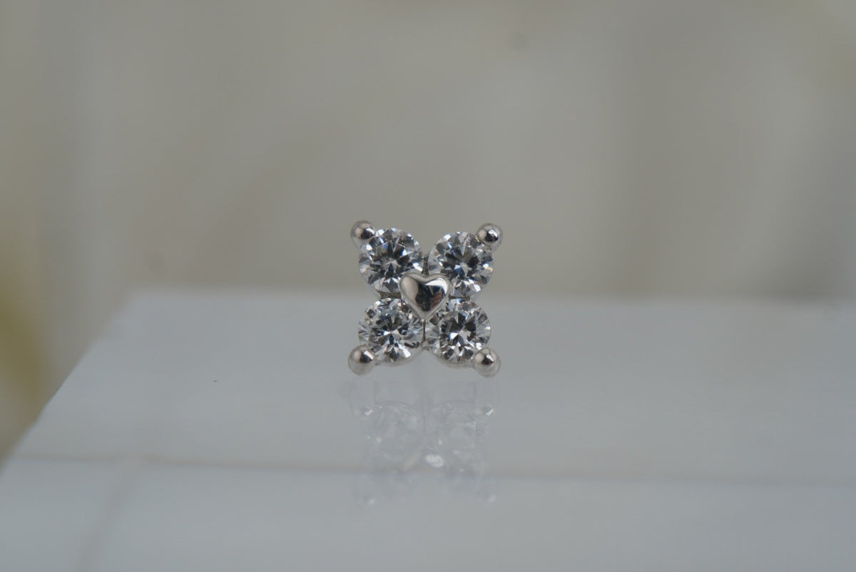 Front view of Buddha Jewelry’s “Corazon” in 14k white gold, featuring four shimmering crystals arranged around a polished gold heart.