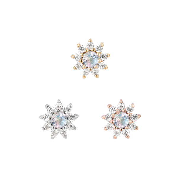 Stock image of Buddha Jewelry’s “Eloise” in 14k yellow, white, and rose gold, featuring rainbow moonstone flowers with white sapphire petals.