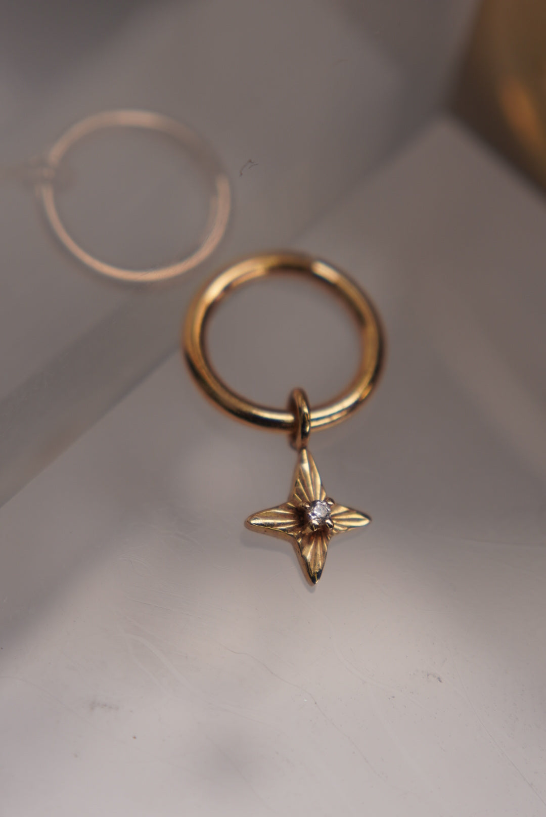 Angled view showing the star’s cutout details and crystal setting.